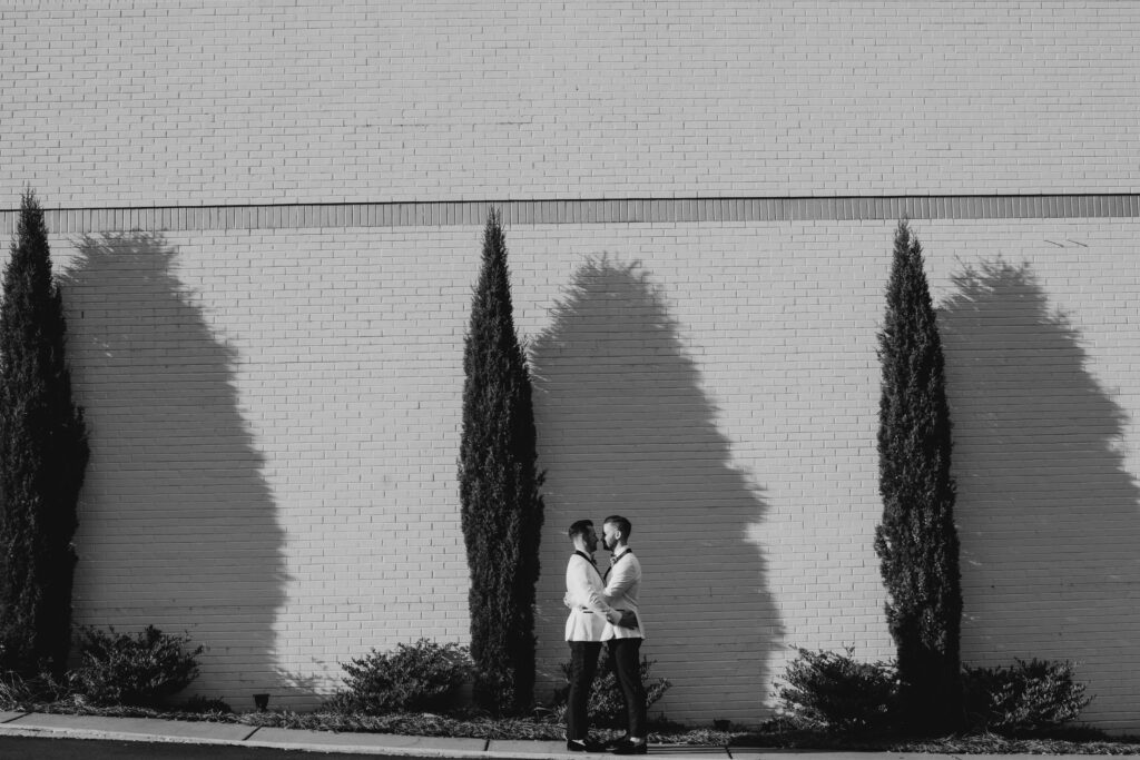 Grooms hugging outside The Club in Birmingham, Alabama