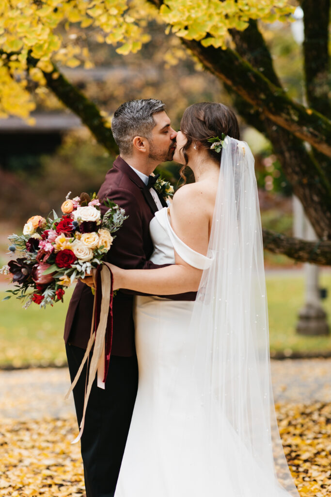 Bride and groom with bouquet at Aldridge Gardens