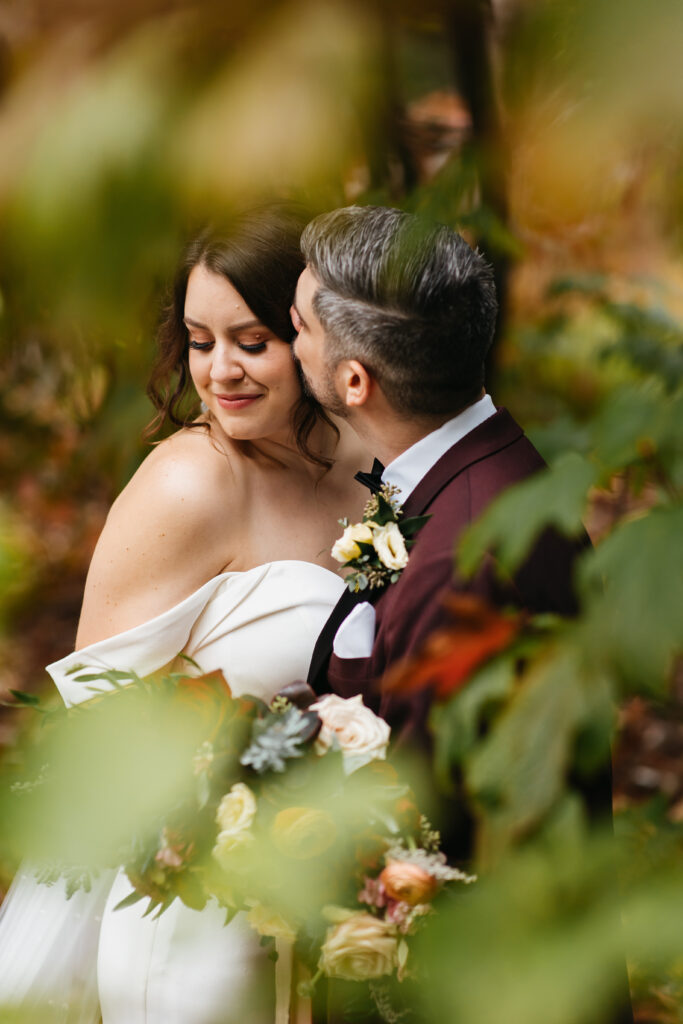Bride and groom with bouquet at Aldridge Gardens