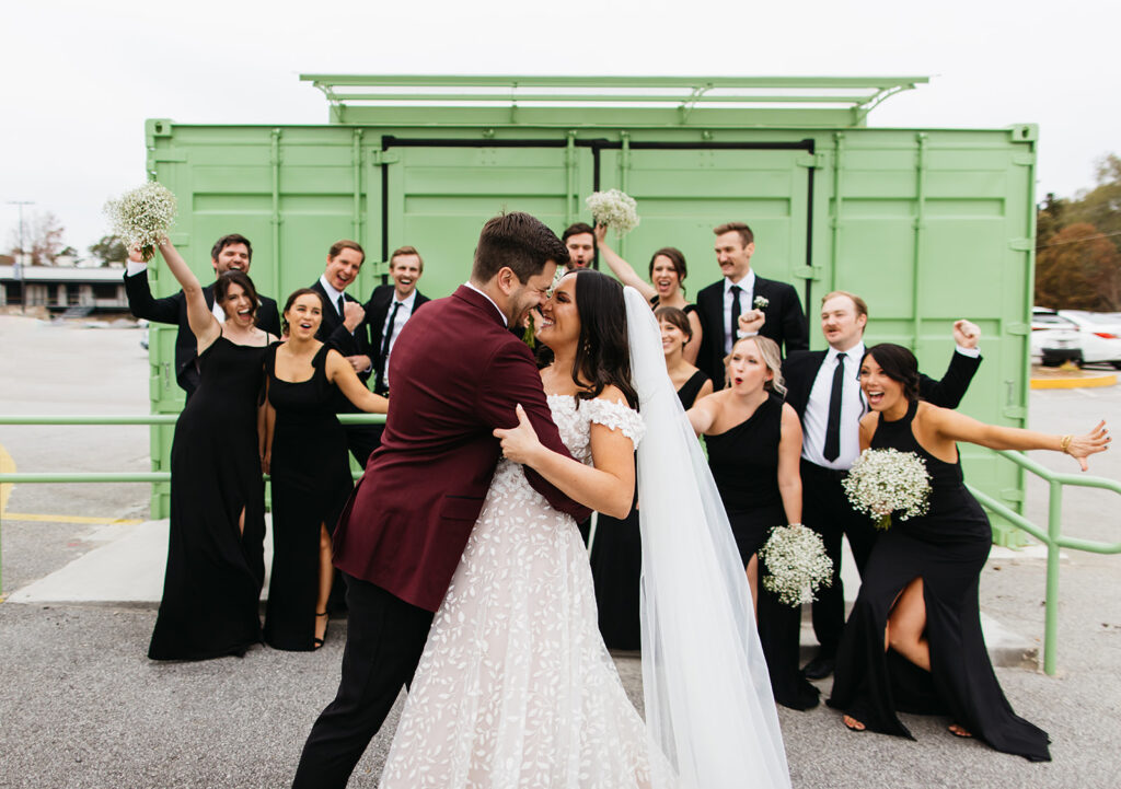 bridal party photos in front of colorful wedding venue