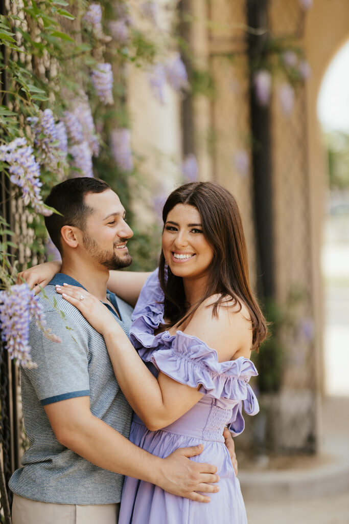 couple holding each other for spring engagement photos