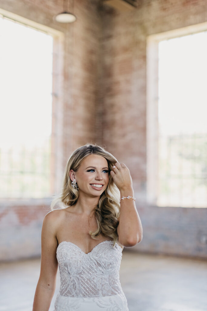 bride moving hair out of face for bridal portraits
