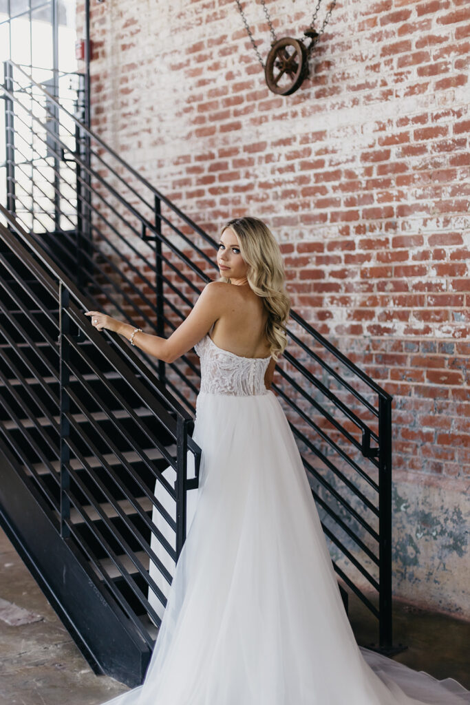 bride looking over her shoulder walking up stairs