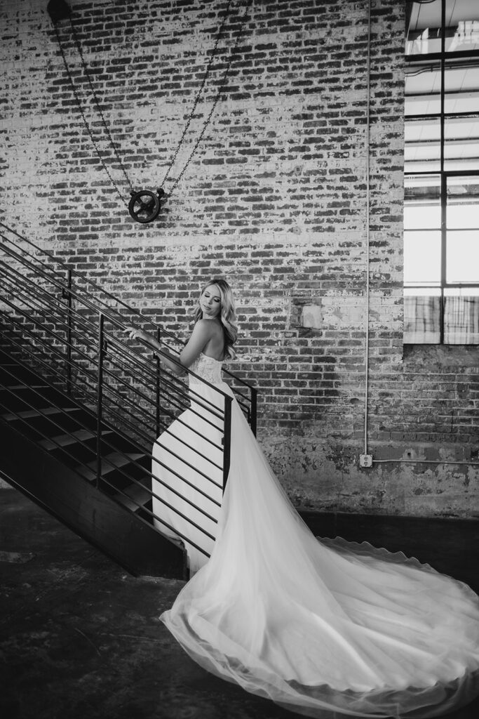 bride looking over shoulder walking up the stairs