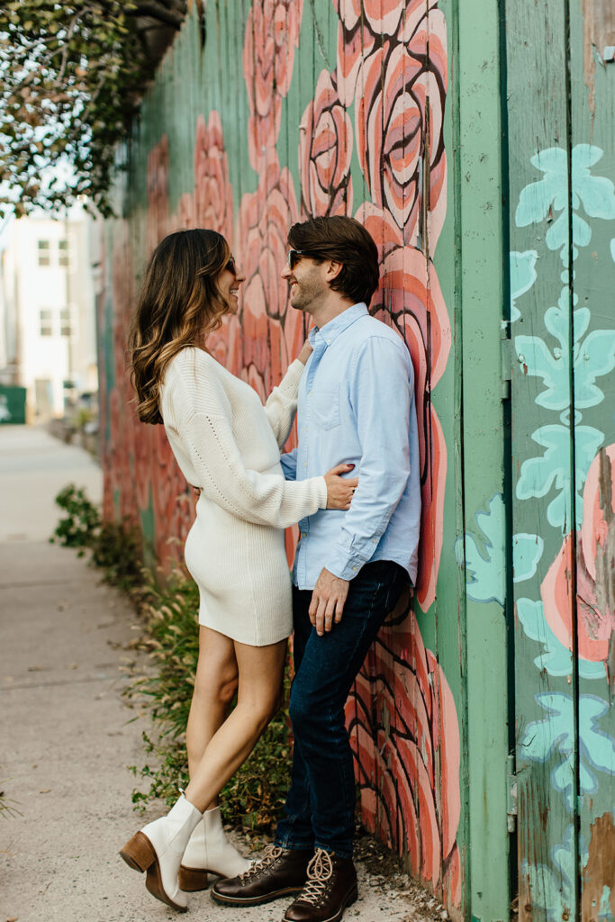 couple leaning against wall for philadelphia engagement pictures