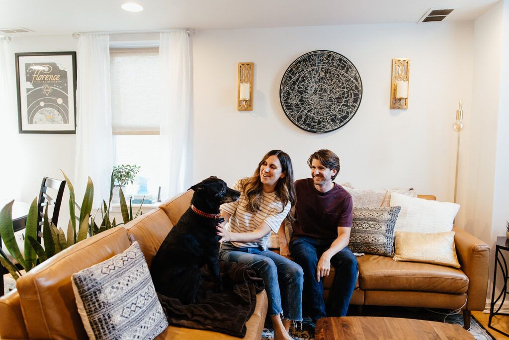 couple smiling and laughing with dog for philadelphia engagement pictures