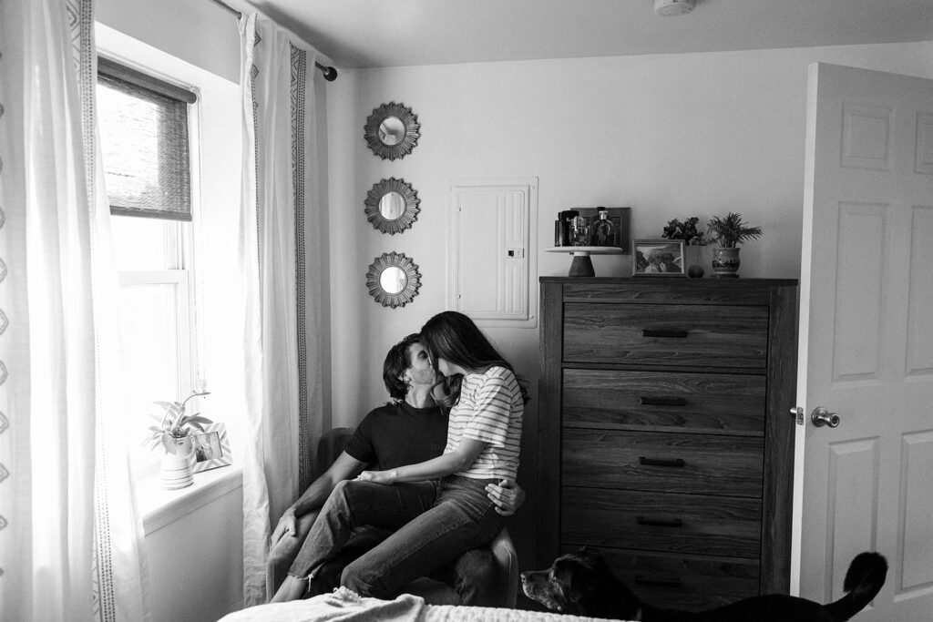couple kissing in chair at home