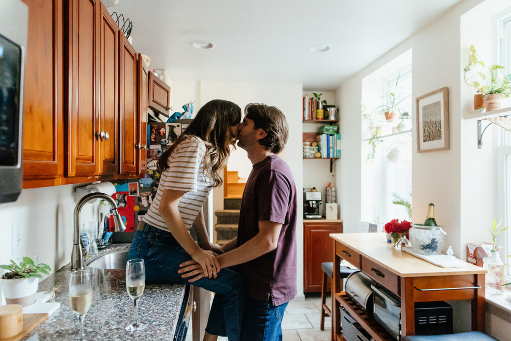 couple sitting on kitchen counter for philadelphia engagement pictures