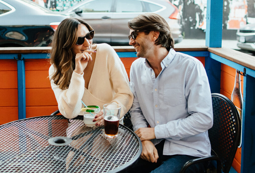 couple smiling and laughing at a bar