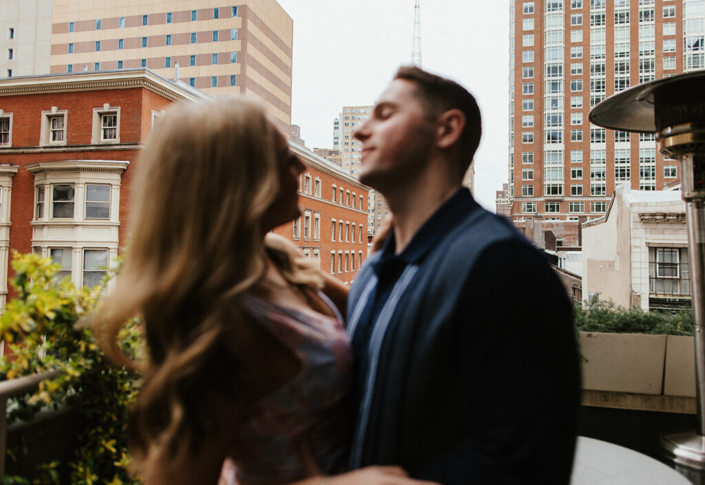 couple smiling in front of city
