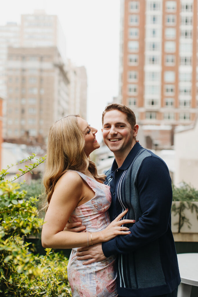 couple smiling and laughing in front of city