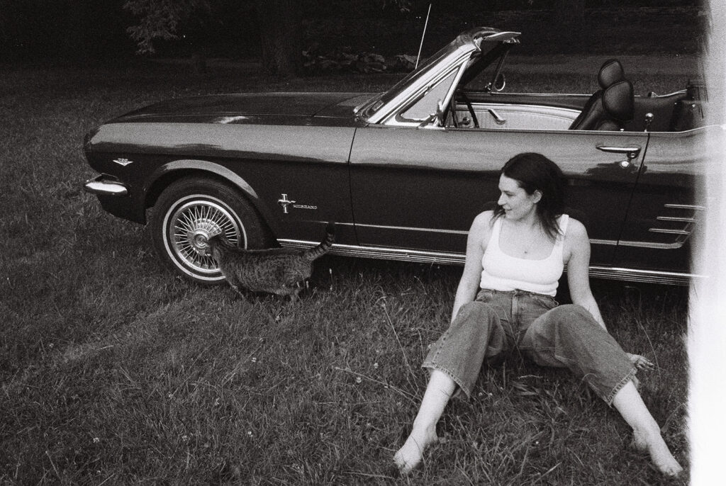 black and white film photography portrait session with vintage car